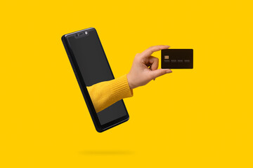 bank card in hand sticking out of the smartphone screen