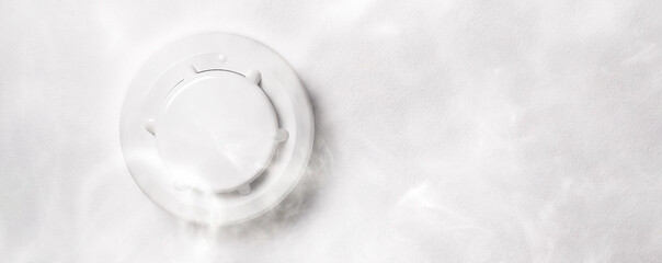 Smoke detector mounted on roof in apartment