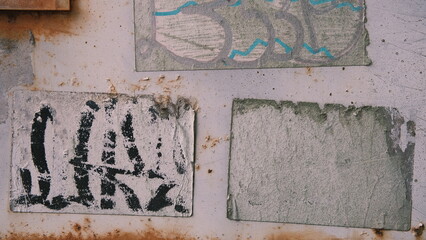 peeling graffiti stickers on old rusty metal texture