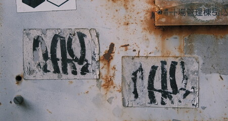 peeling graffiti stickers on old rusty metal texture