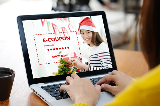 Woman entering Christmas discount coupon code on laptop screen to get the shopping online promotion, online shopping ,digital marketing business and technology