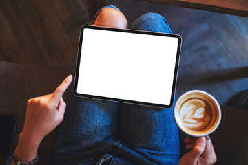 Top view mockup image of a business woman holding digital tablet with blank white desktop screen while drinking coffee