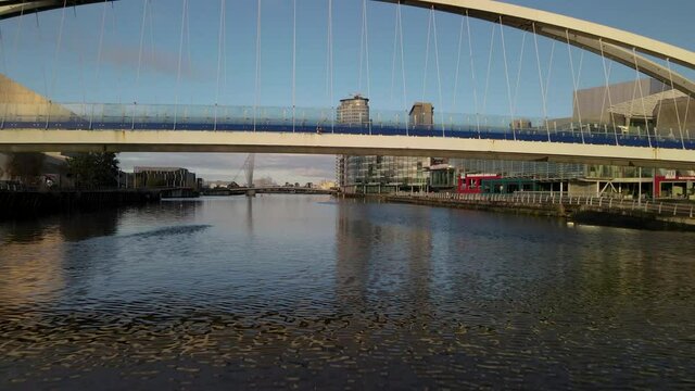 Drone clip passing under a bridge in Salford quays in Manchester, England