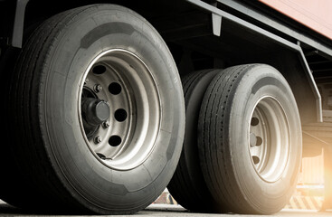 Naklejka na ściany i meble Large a truck wheels tires of trailer truck. Road freight. Logistics and transportation.