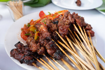 One of the typically Indonesian foods is satay or sate. This food is made from beef or mutton or chicken which is grilled over smoky coals then served with peanut sauce and soy sauce.