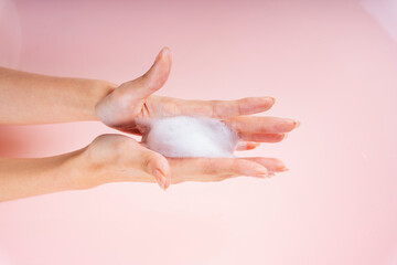 Woman hands with lotion foam.