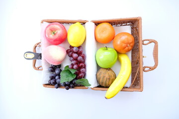 seasonal fruit in basket on white background