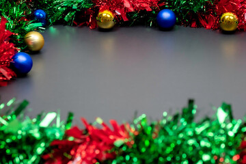Christmas border template with fir branches, Beautiful red green blue and gold toys and ribbon,on space gray color background, Merry Christmas and Happy New Year.