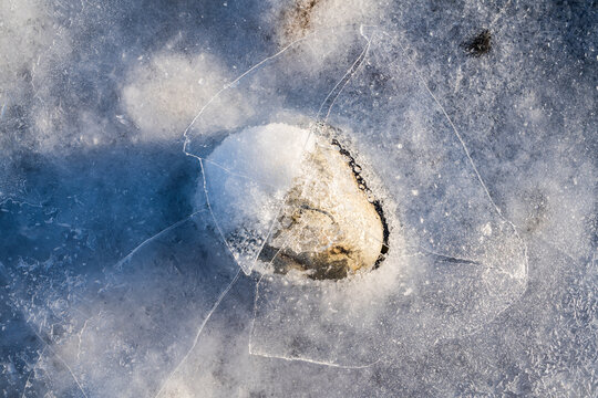 Rock Breaking Through The Ice