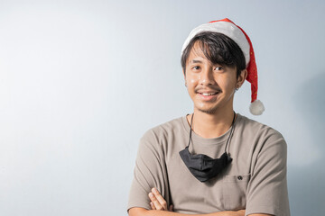 Young asian man Smiling, with Santa Claus hat
