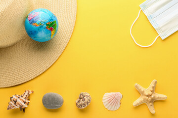 Tourist theme: hat, seashells, starfish, rock, a medical mask , the globe on a bright yellow background, center space for text. The globe shows South America, North America, USA. Coronavirus. Banner.