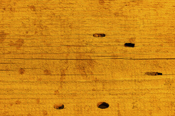 The texture of a wooden board, tinted in gold. Trending color 2021. Trending background in Fortuna Gold color 2021. Close-up background, backdrop for design, art. DAA520