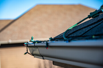 Hanging Christmas lights on gutter with plastic clips