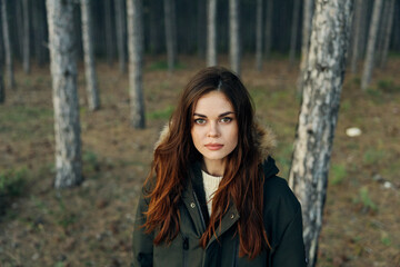 woman walking in the woods in jackets outdoors travel