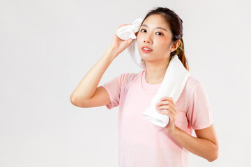 Asian woman holds a towel around her neck after exercising on white background