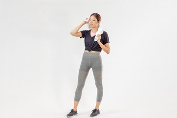 Asian woman standing on a white wall background with copy space, exercises for weight loss, flexibility and toning.