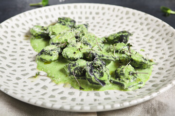 Black ravioli with shrimp and spinach sauce