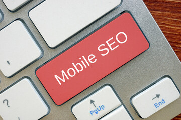 Financial concept meaning Mobile SEO  with sign on the page.