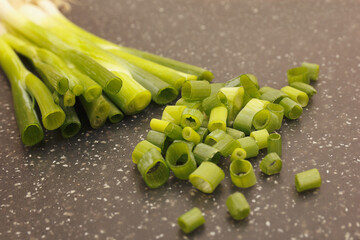Chopped leek on a marble cutting board close up.