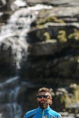 man before waterfall