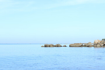 Fototapeta premium the blue sky in the morning at the beach and group of rocks during summer holiday at Pattaya beach , Thailand