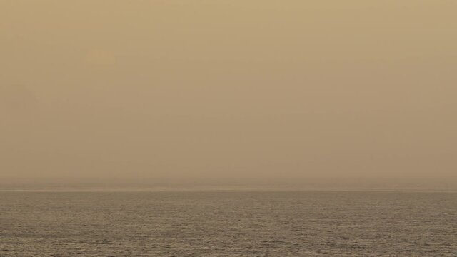 Sandstorm from Africa.
Yellow Sun rises over the Ocean behind a Sandy mist.
Dense Calima moves across the Canaries. It is a kind of sand storm from the Sahara.