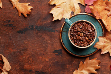 Coffee cup and autumn leaves