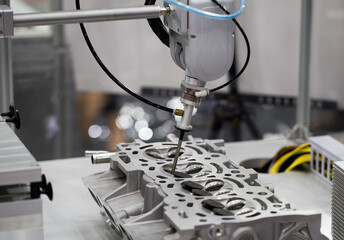 Industrial robot arm demonstrate assembly engine part. Automotive industry