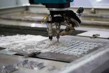 Modern CNC Abrasive water jet cutting machine using high pressure water jet to cut metal....