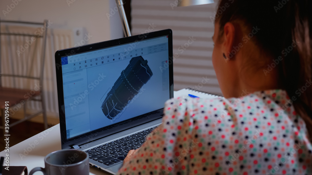 Poster engineer working late at night on a 3d model of industrial turbine from home. remote freelancer stud