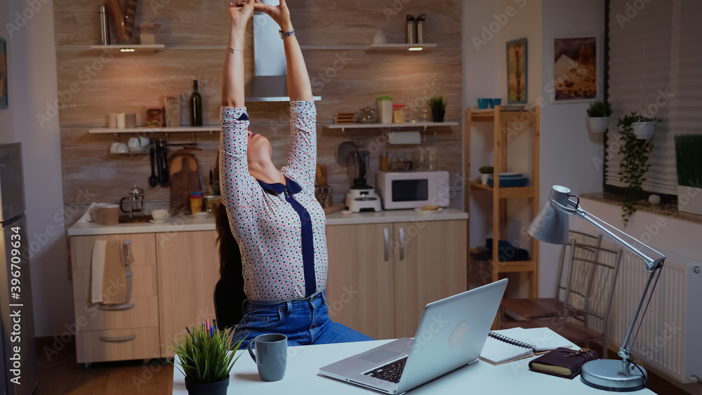 Poster exhausted remote employee streching while working on a deadline late at night. busy focused freelanc
