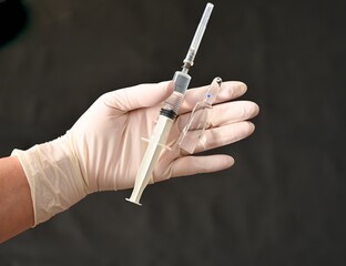 Syringe and new vaccine in the hand of a doctor. Covid-19
