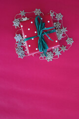 Gift box for Christmas on red background with copy space