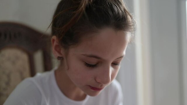 one little caucasian girl eating milk breakfast from plate indoors kitchen