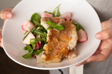 fried perch with vegetables on a plate.