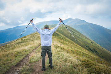 Fototapeta na wymiar Hiker Man in a summer mountains. Trekking and outdoor concept. 