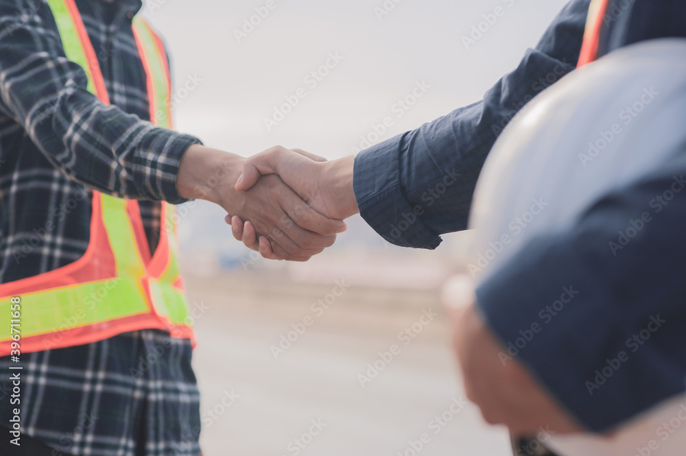 Wall mural close up people shake hand outdoor success construction