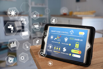 Tablet computer with application of smart home automation on table in kitchen