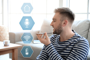 Man with mobile phone in room. Modern technology and smart home automation