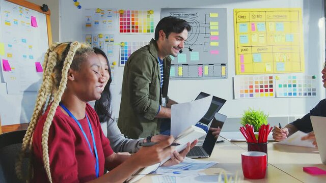 Meeting of ux developer and ui designer brainstorming about mobile app interface workflow design on table with coworker breif and color code at co-working space.Creative digital development agency
