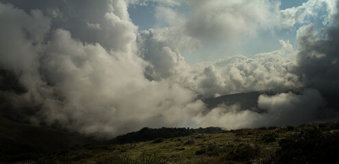 Obraz na płótnie Canvas Dramatic cloudy sky in the high mountains. Beautiful landscape in the mountains of 