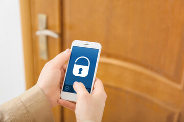 Woman using mobile phone to open door