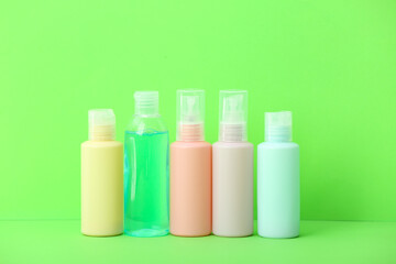 Obraz na płótnie Canvas Set of travel bottles with body care cosmetics on color background