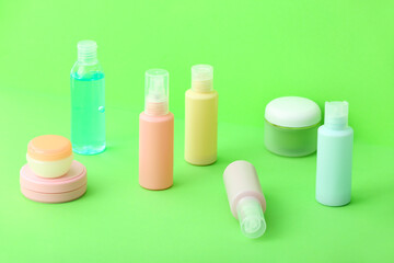 Set of travel bottles with cosmetic products on color background