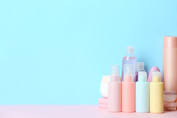 Travel cosmetics kit on color background