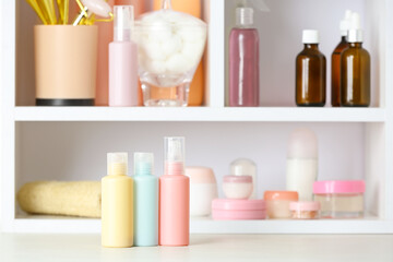 Set of travel bottles with body care cosmetics on white table