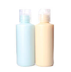 Set of travel bottles with body care cosmetics on white background
