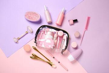 Travel cosmetics kit and transparent bag on color background