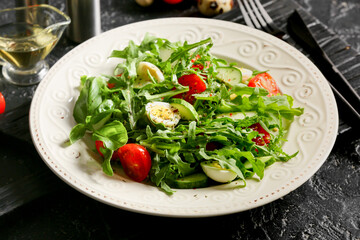 Plate with tasty arugula salad and ingredients on dark background