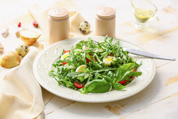 Plate with tasty arugula salad and spice on light table